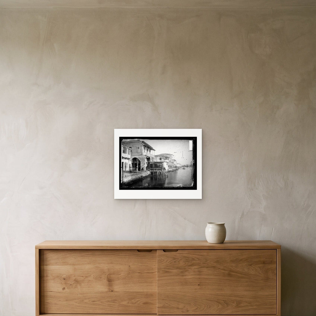 John Thomson – Waterfront Houses, Larnaca, Cyprus, 1878 — the 50 × 40 cm sheet as printed, shown on the wall above a sideboard