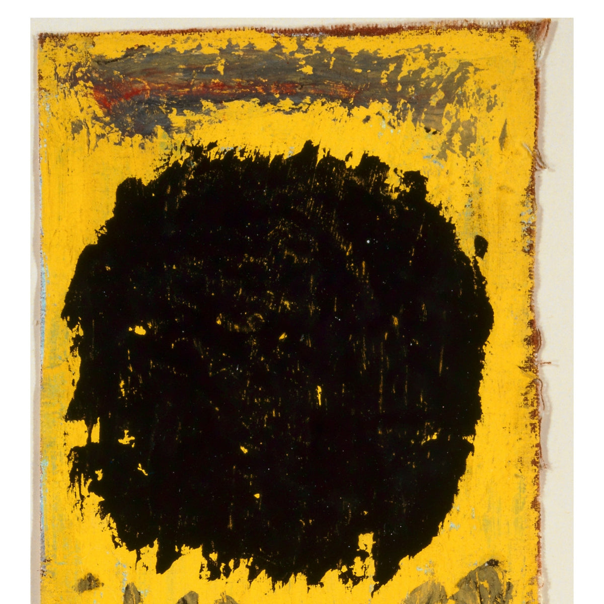 Detail at print size: the black disc in thick, dry tempera on the yellow ground, with the frayed top edge of the canvas