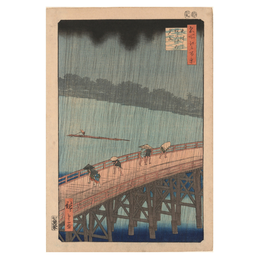 Utagawa Hiroshige, Sudden Shower over Shin-Ōhashi Bridge and Atake, 1857 — the woodblock sheet reproduced whole, black rain lines falling across a wooden bridge, the deep sky band and the blue water unfaded