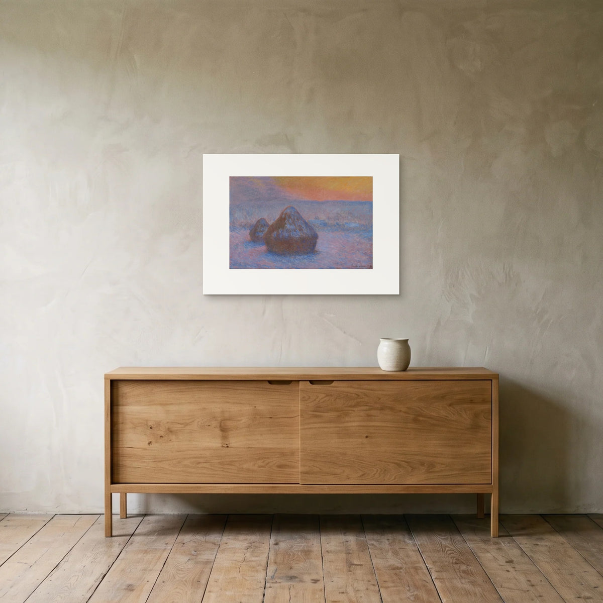 Monet, Stacks of Wheat (Sunset, Snow Effect) — the 70 × 50 cm print hung above an oak sideboard