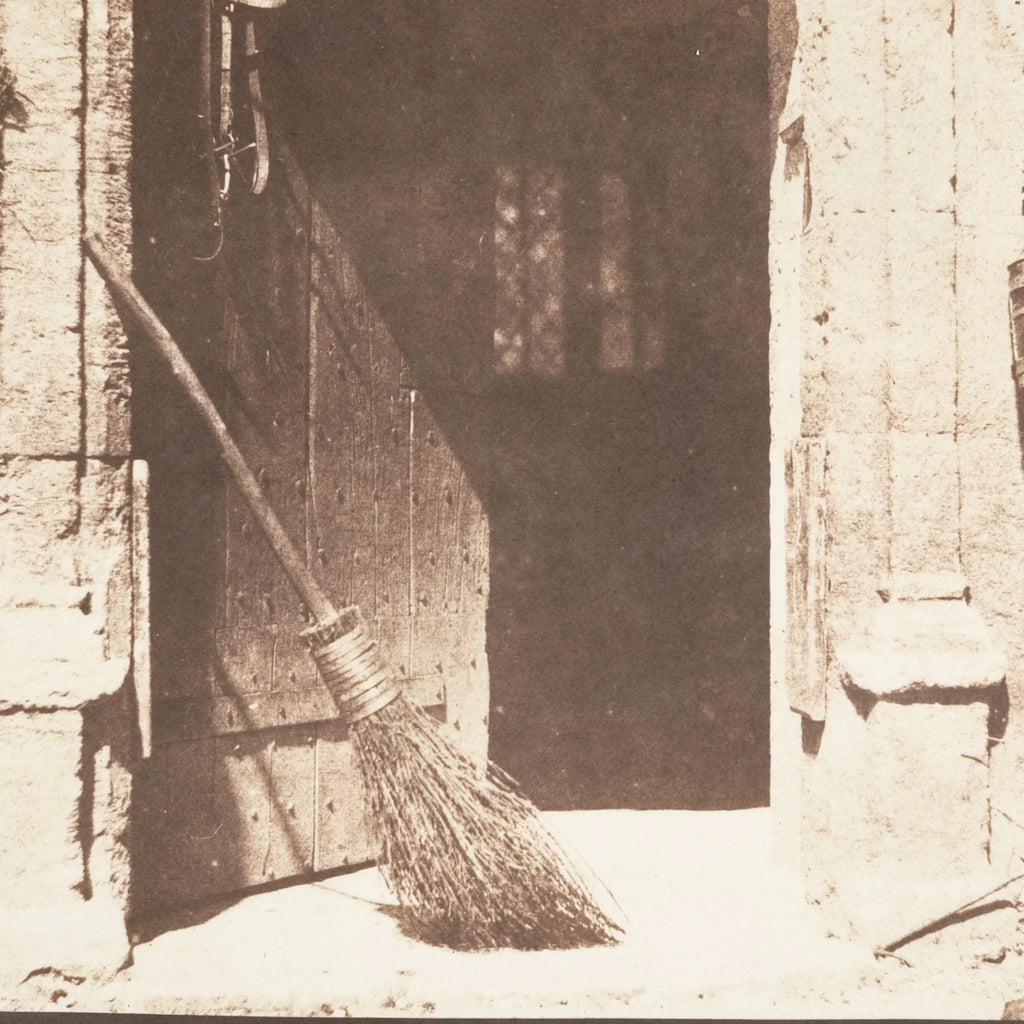 Detail at printed size — the broom leaning in the doorway