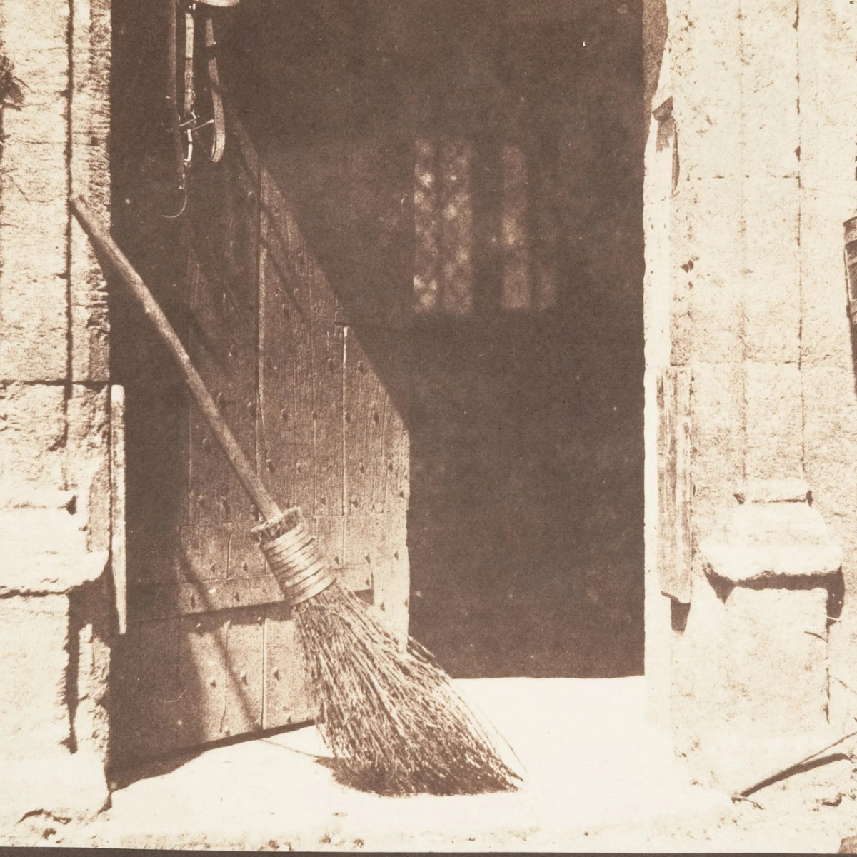 Detail at printed size — the broom leaning in the doorway