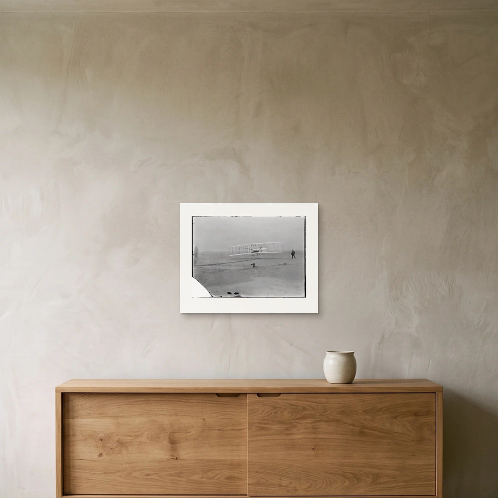 The first flight as a 50 × 40 cm giclée print, unframed, hung above an oak sideboard